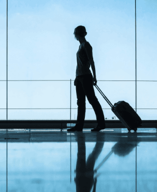 Person standing in front of airport window